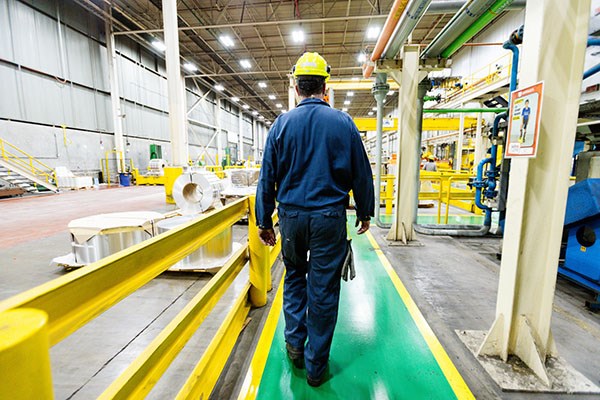Employee walking safely using the pedestrian safety.