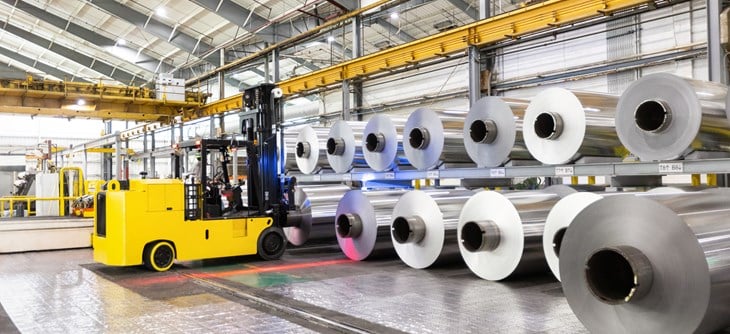 Fork lift organizing aluminium coils.