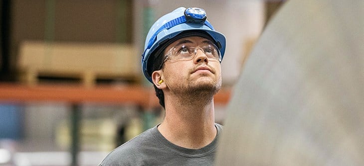Employee looking up at aluminium coil.