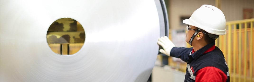 Employee touching an aluminium coil.