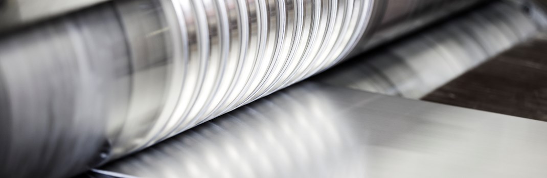 Sheet of flat rolled aluminium being manufactured.