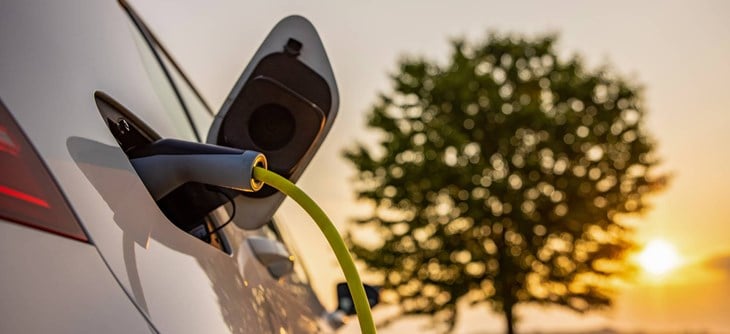 Close up of electric car plugged into charger.