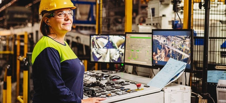 Employee operating a control panel.