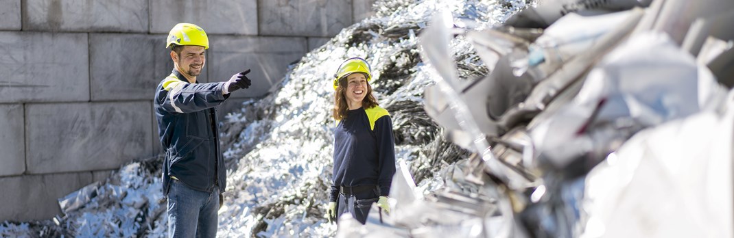 Two employees at an aluminium scrap yard.